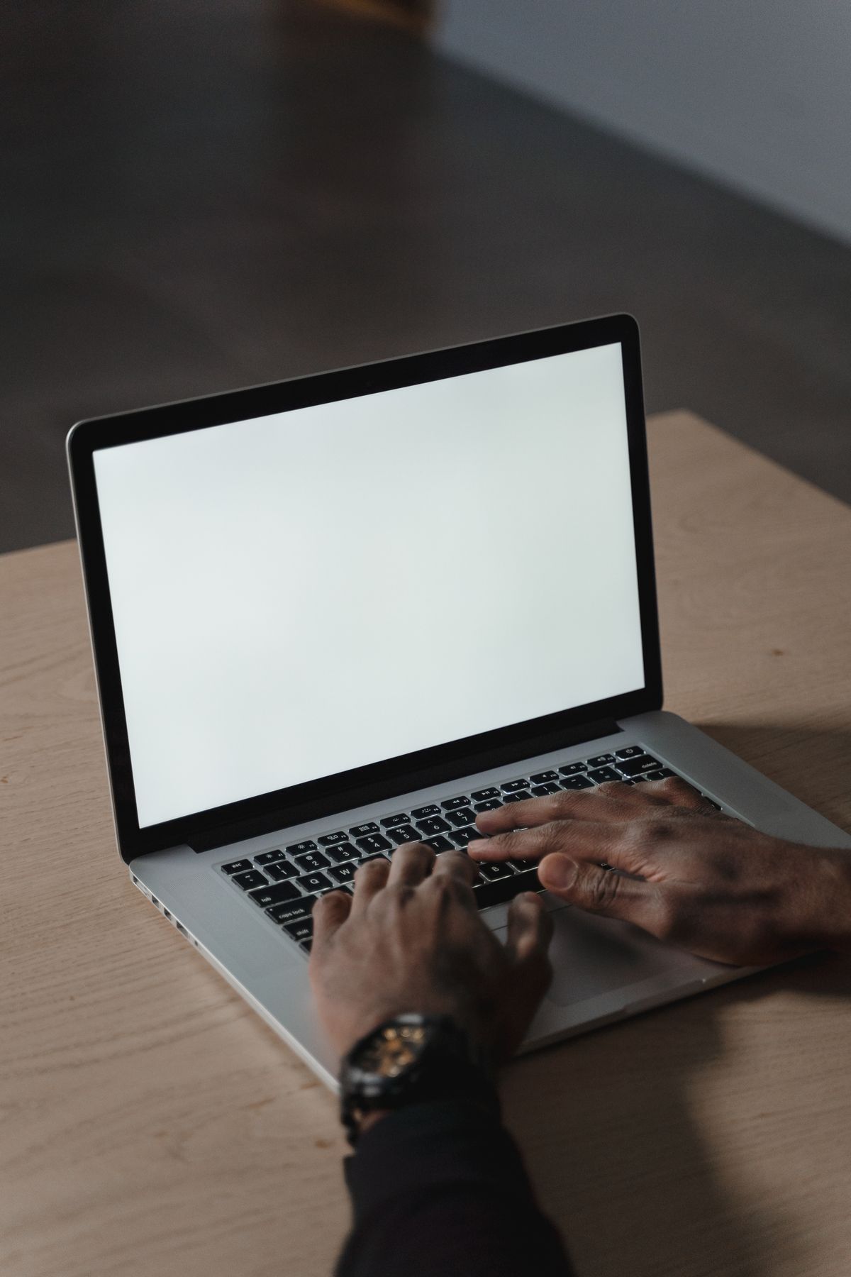 Hands typing on a laptop keyboard